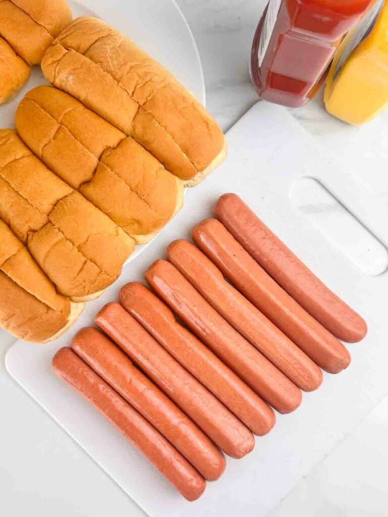 Air fryer hot dogs ingredients needed: hot dogs, buns, and condiments.