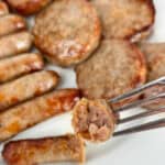 Ready to serve breakfast patties and links with a bite sized piece in a fork.