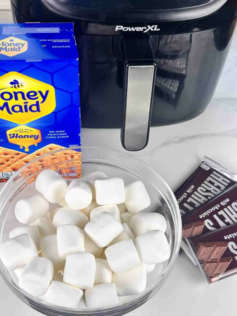 Air fryer smores ingredients; marshmallows, graham crackers, and chocolate bars.
