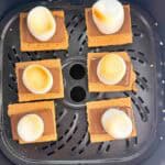 Air fryer graham crackers ready to put a top on in an air fryer basket.