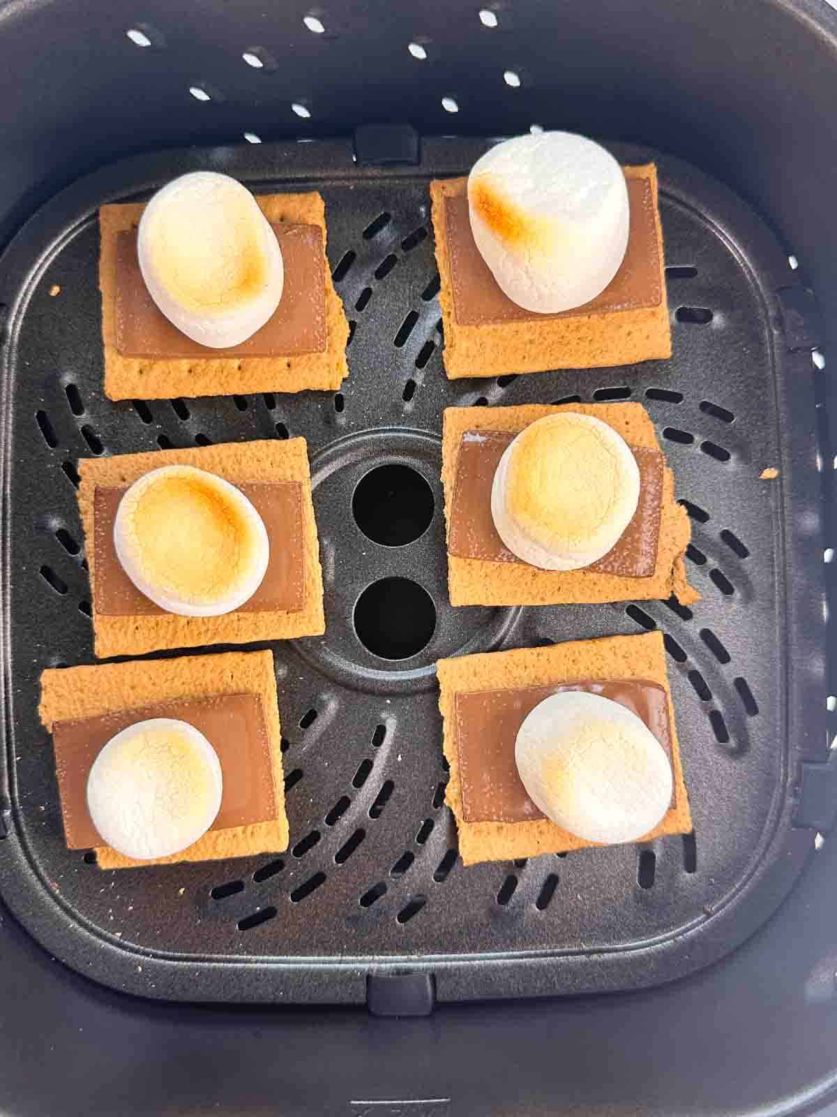 Air fryer graham crackers ready to put a top on in an air fryer basket.