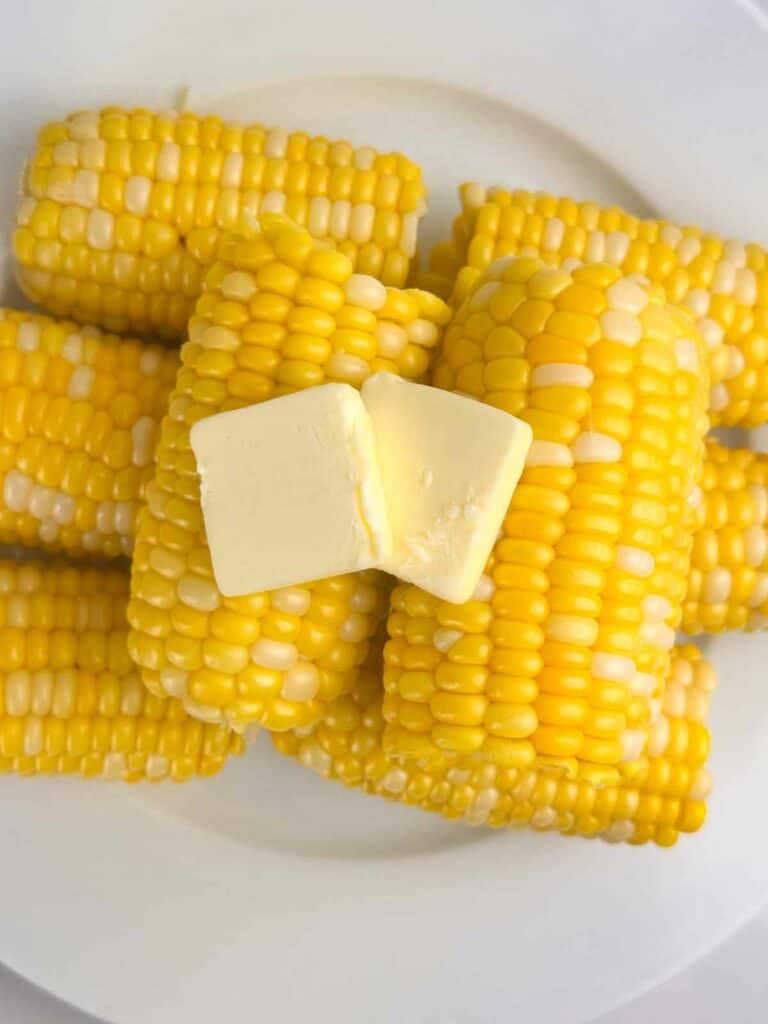 Corn on the cob with butter on top.