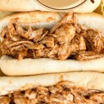 Image of three rolls with shredded chicken and BBQ sauce, text reads instant pot shredded chicken, whatacrockof.com